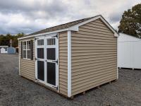 10x14 peak series shed in pebble clay straight lap vinyl siding with white trim and corners, black shutters and door, and weatherwood shingles.